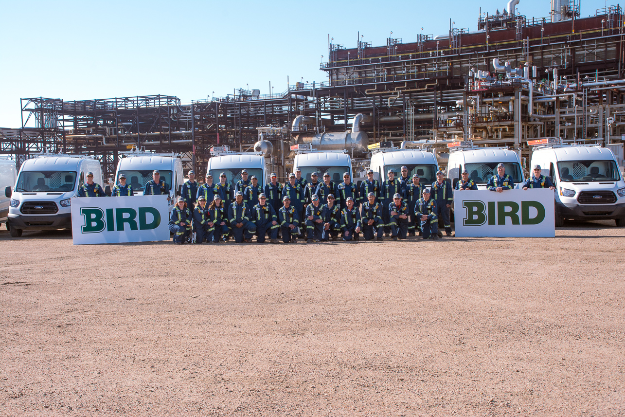 Bird Team in front of industrial site