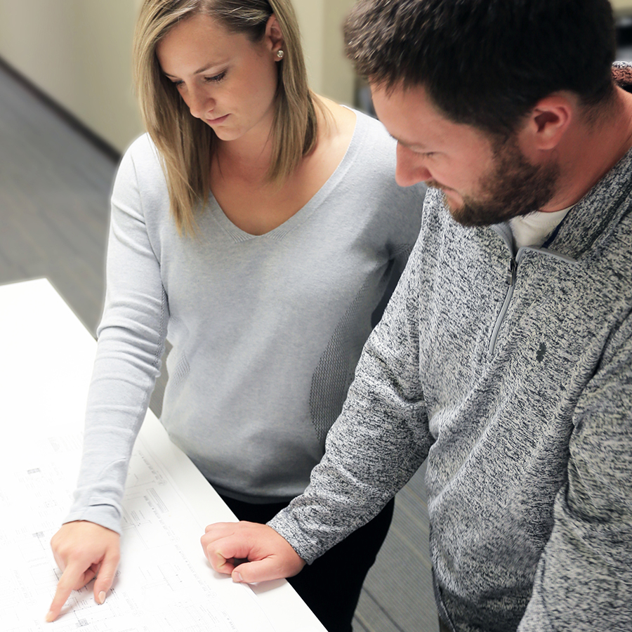 Two employees looking at drawing