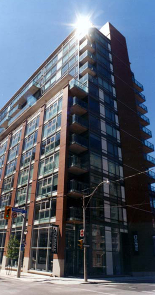 Exterior shot of a brick condominium building 