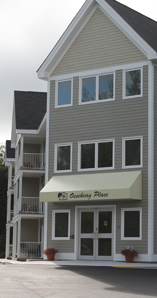Exterior of Ossekeag Place showing the front entrance, including branded front awning