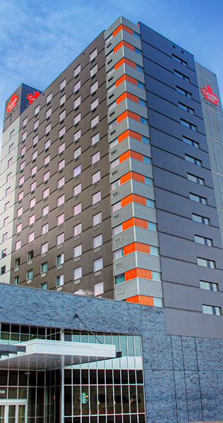 Exterior view of the Canad Inns Destination Centre showing orange accents on the building corners