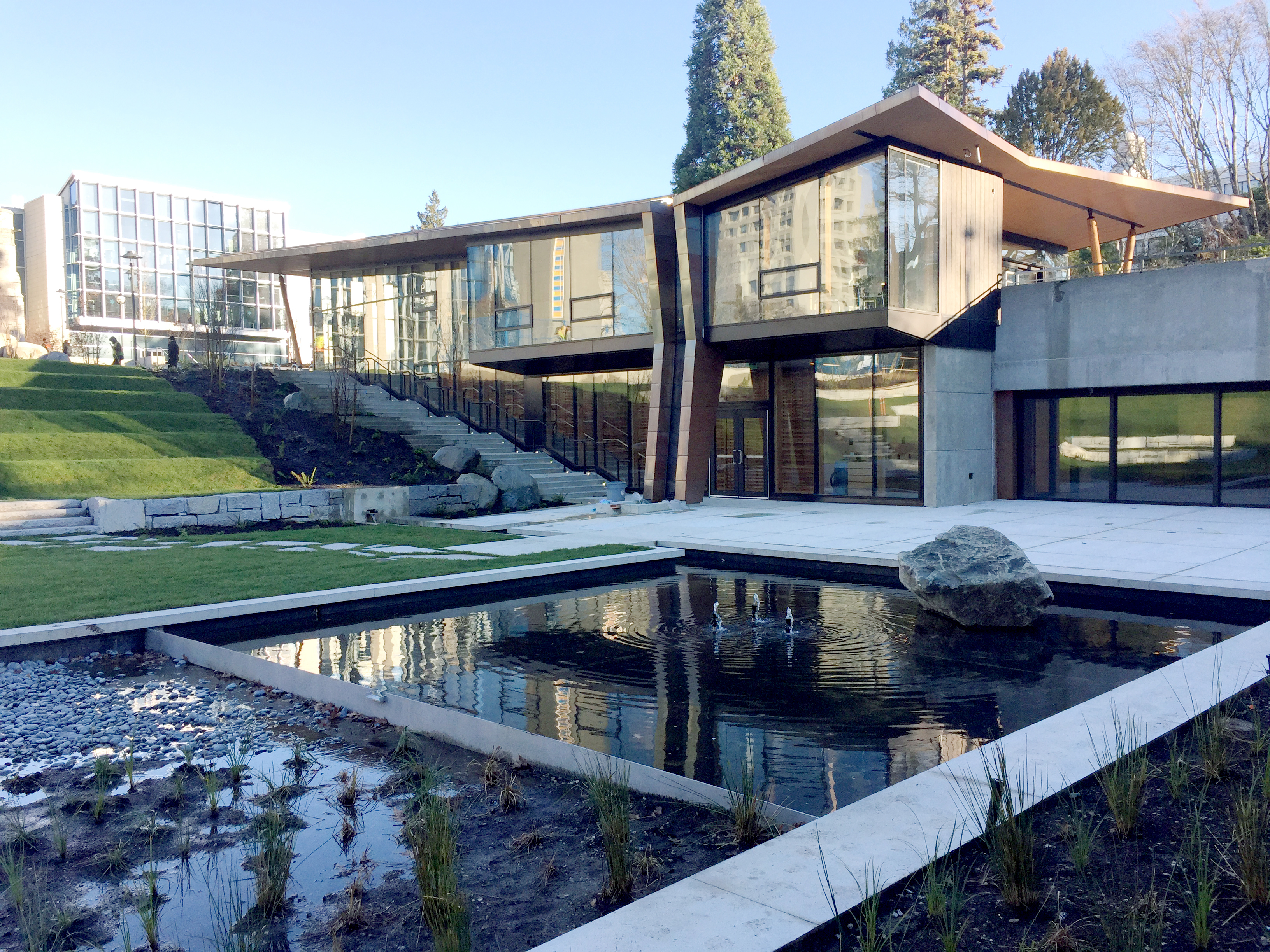 Exterior view of UBC IRSHDC showing pond, landscaping and building facade