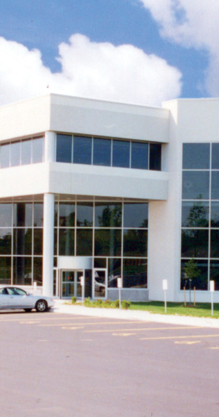 White Concrete and Black Glazed Facade with Entrance Doors