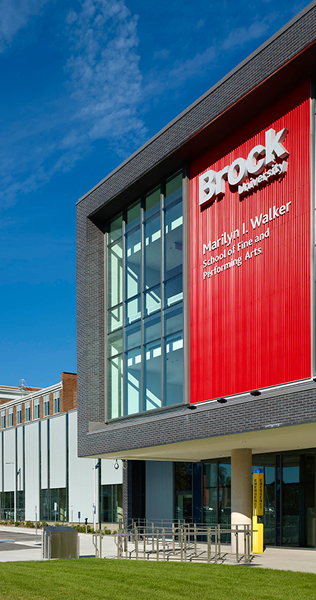 Front facade of the Brock University Marilyn Walker building showing red building signage 