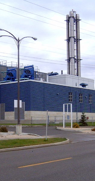 Painted Masonry Building Facade with Mechanical Rooftop Equipment and Smoke Stacks
