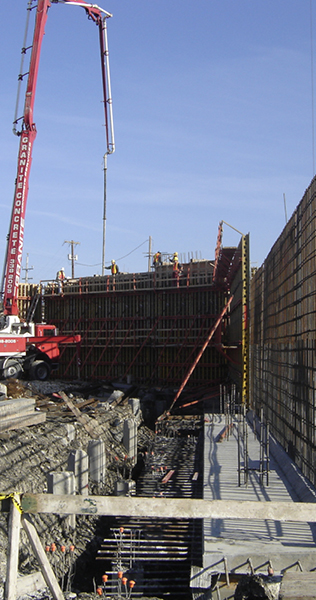 Construction Progress Showing Foundation and Exposed Rebar, Forming Walls and Concrete Pumper Truck