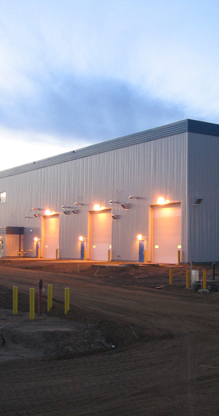 Exterior view of maintenance building with lights above bay doors