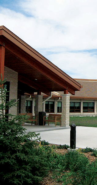 Exterior Landscaping and Sheltered Patio with Masonry Columns and Gable Roof