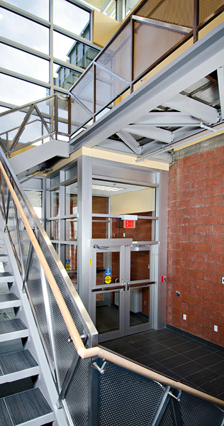 Exposed Structural Steel Walkway with Stairwell above Exit Doors