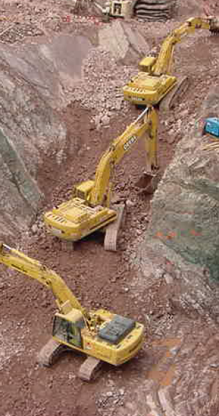 Aerial View of Three Excavators Digging Among Rock and Earth