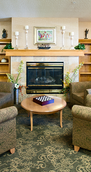 Armchairs around a Coffee Table with Boardgame In Front of Fireplace