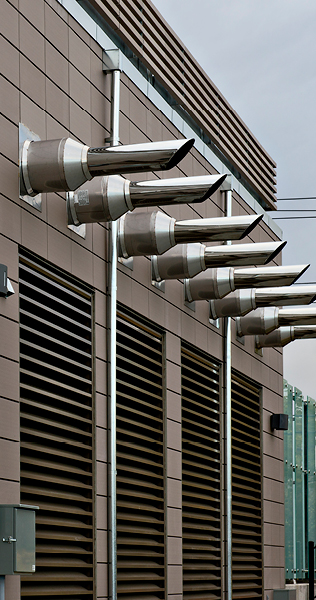 Exterior Building Terminus of Horizontal Chromed Exhaust Pipes
