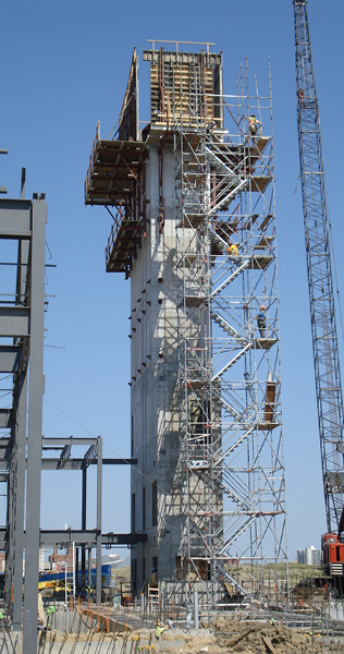 Tower With Forming Panels On Top Alongside Scaffolding and Structural Steel