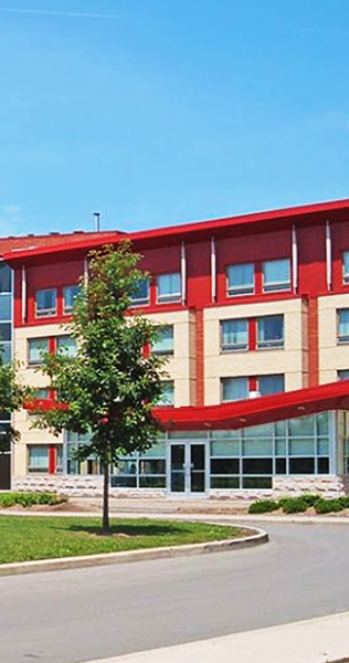 Exterior of the Sheridan College Student Residence showing red facade accents