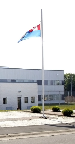 Landscaped Front Entrance With Flagpole