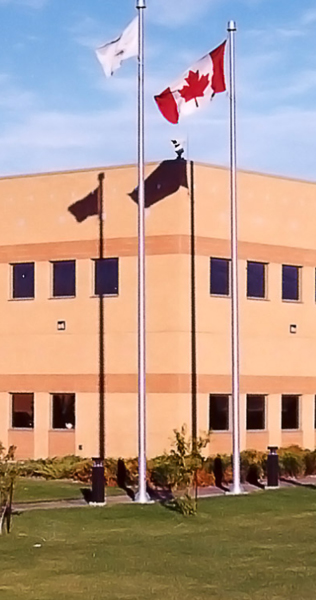 Landscape and Corner Facade of Brick with Flagpoles