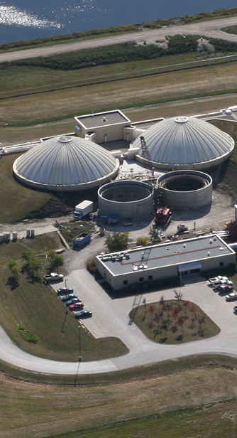Aerial View of Construction of Two Cylindrical Concrete Storage Tanks with Mobile Crane