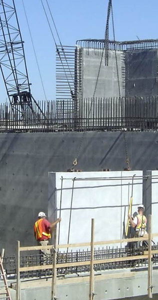 Workers Positioning a Concrete Panel