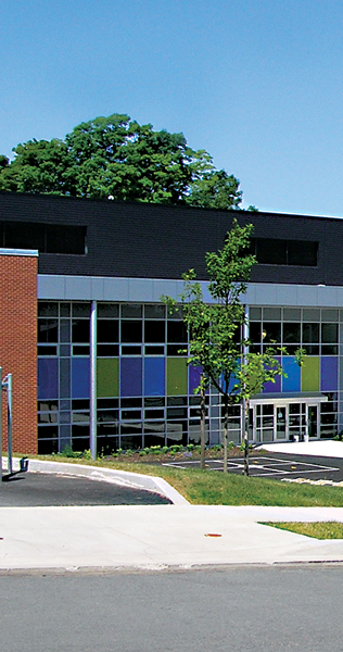 Landscaping with Glazed Building Facade and Blue and Green Coloured Panels