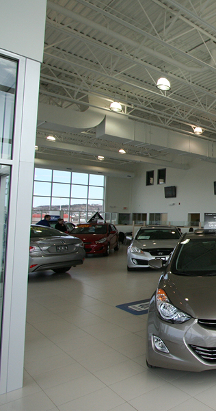 Interior Showroom with Vehicles and Exposed Ceiling