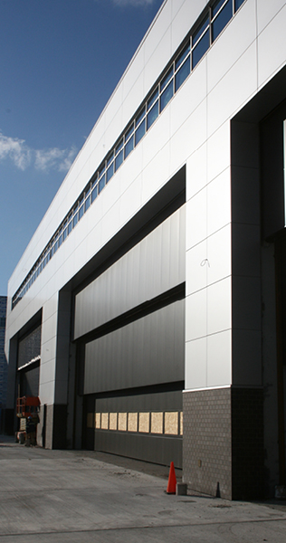 Brick and Aluminium Composite Paneled Facade with Vertical Lift Overhead Doors