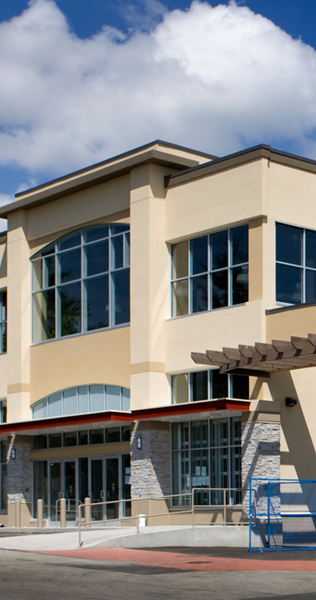 Stuccoed and Glazed Facade with Canopied Entrance