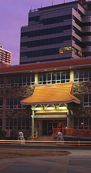 Exterior of the Avatamsaka Monastery at dusk, with the entrance lit up