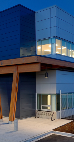 Exterior corner of Canada Post Pacific Processing Centre showing support struts and bike rack