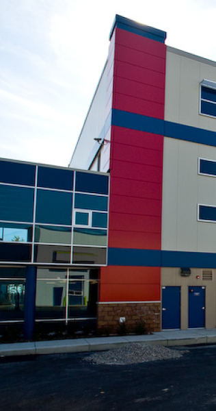 Exterior of the Larco Office and Warehouse showing side of building with red and blue cladding