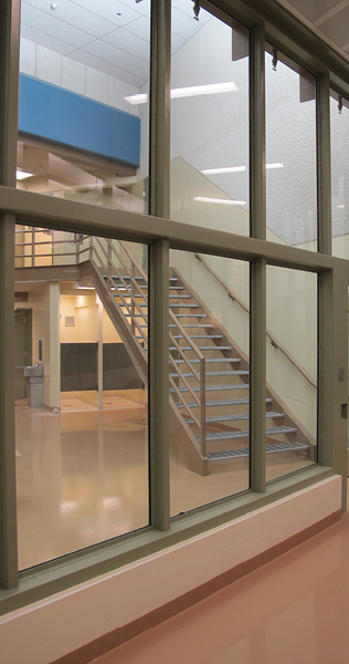 Interior of Milner Ridge Correctional Centre showing glass enclosed walkway and interior staircase