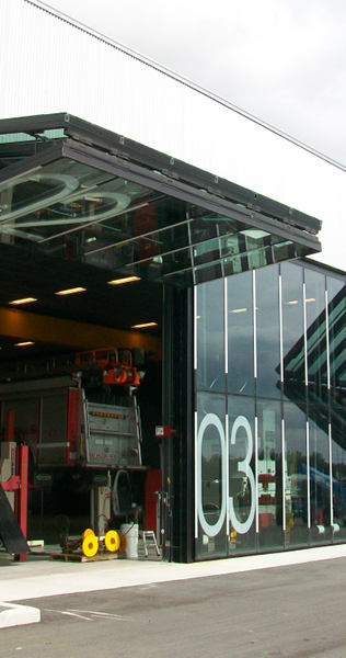 Open glazed glass bay door showing equipment inside