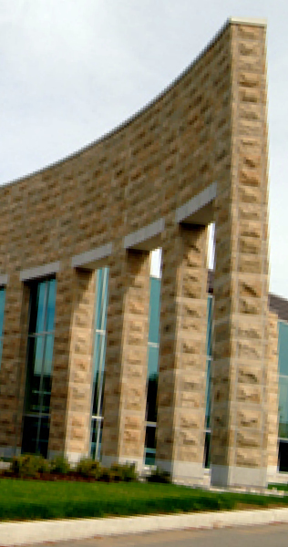 Exterior details of Viva Plant showing curved stone clad wall with arches