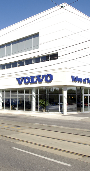 View of exterior entrance to Volvo on Dundas showing white cladding and signage