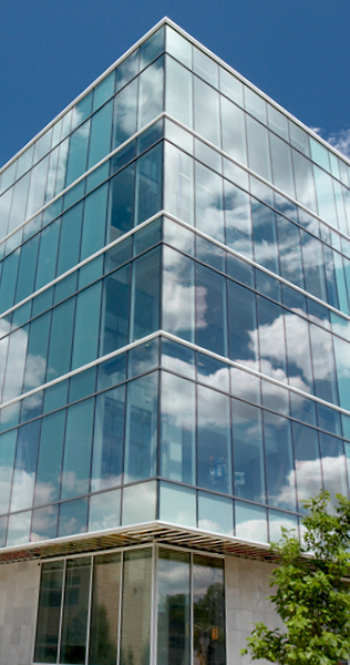 Exterior view of  McMaster University Engineering Technology Building facade, with windows reflecting clouds