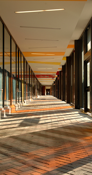 York colonnade showing paved walkway with reflections of coloured glass windows