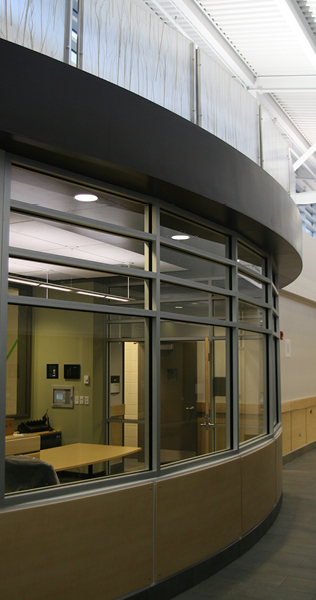 Interior detail of East District Police Station showing curved wall and view into office area