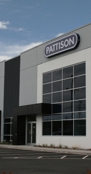 Warehouse Facade with Windows, Front Entrance, and Pattison Signage