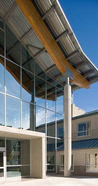 Exterior of Kwantlen University Building C showing roof support details and glass facade