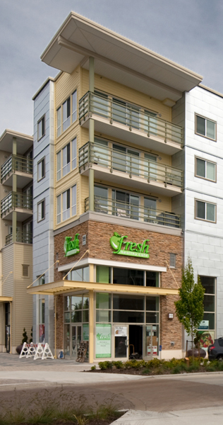 Exterior corner of  Morgan Crossing showing ground floor retail store with apartments above