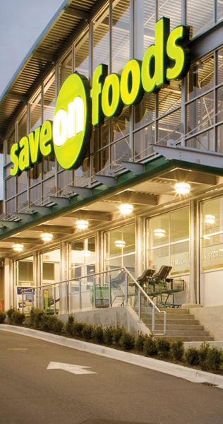 Entrance to Centre of Newton "Save on Foods" shop showing signage and glass facade