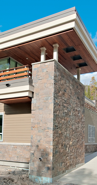 Close up detail of Donald Cameron Centre exterior showing stone clad wall and roof details