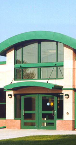 Exterior entrance of the Fitness and Recreation Centre at 17 Wing showing green accents on the building facade
