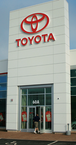 Paneled Tower With Entrance Doors and Toyota Signage