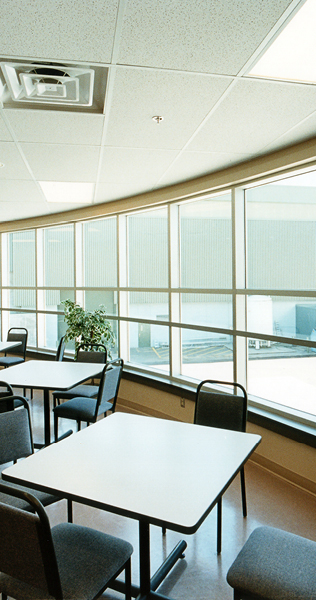 Interior Dining Space with Tables and Chairs Alongside Windows