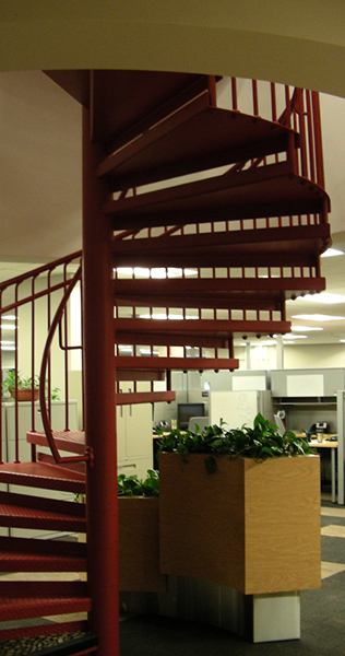 Steel Circular Stairway With Workspaces in the Background