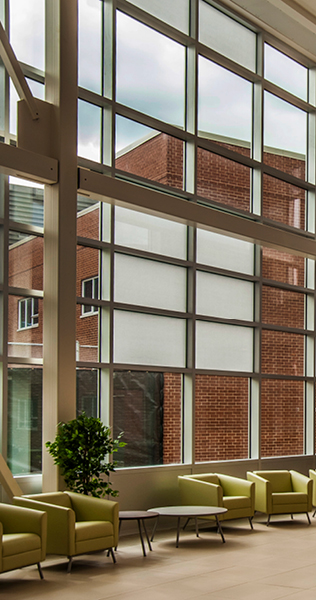 Interior Atrium Seating Area with Glazing Overlooking Brick Wing