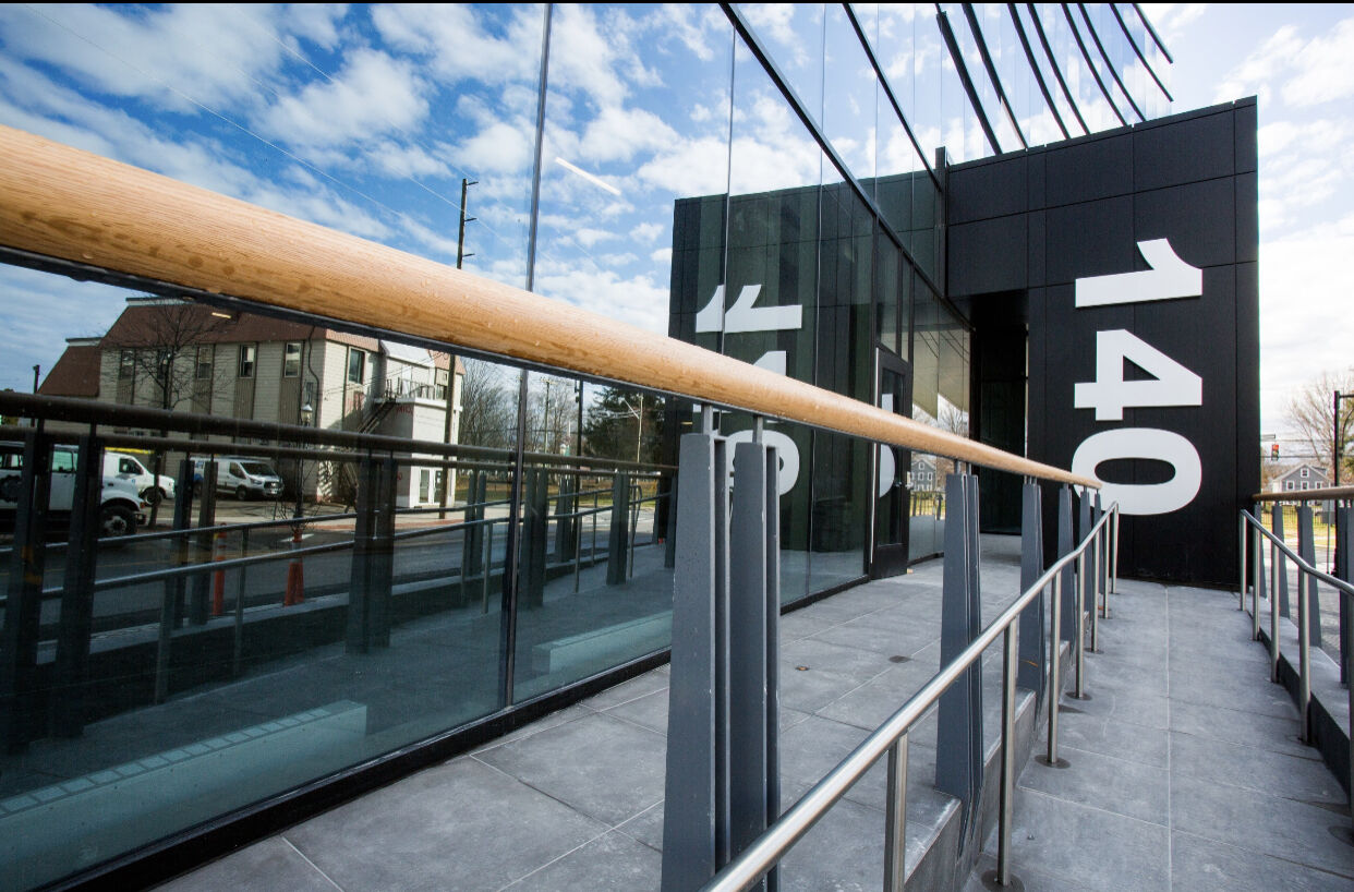 Exterior glass wall with modern wood railing