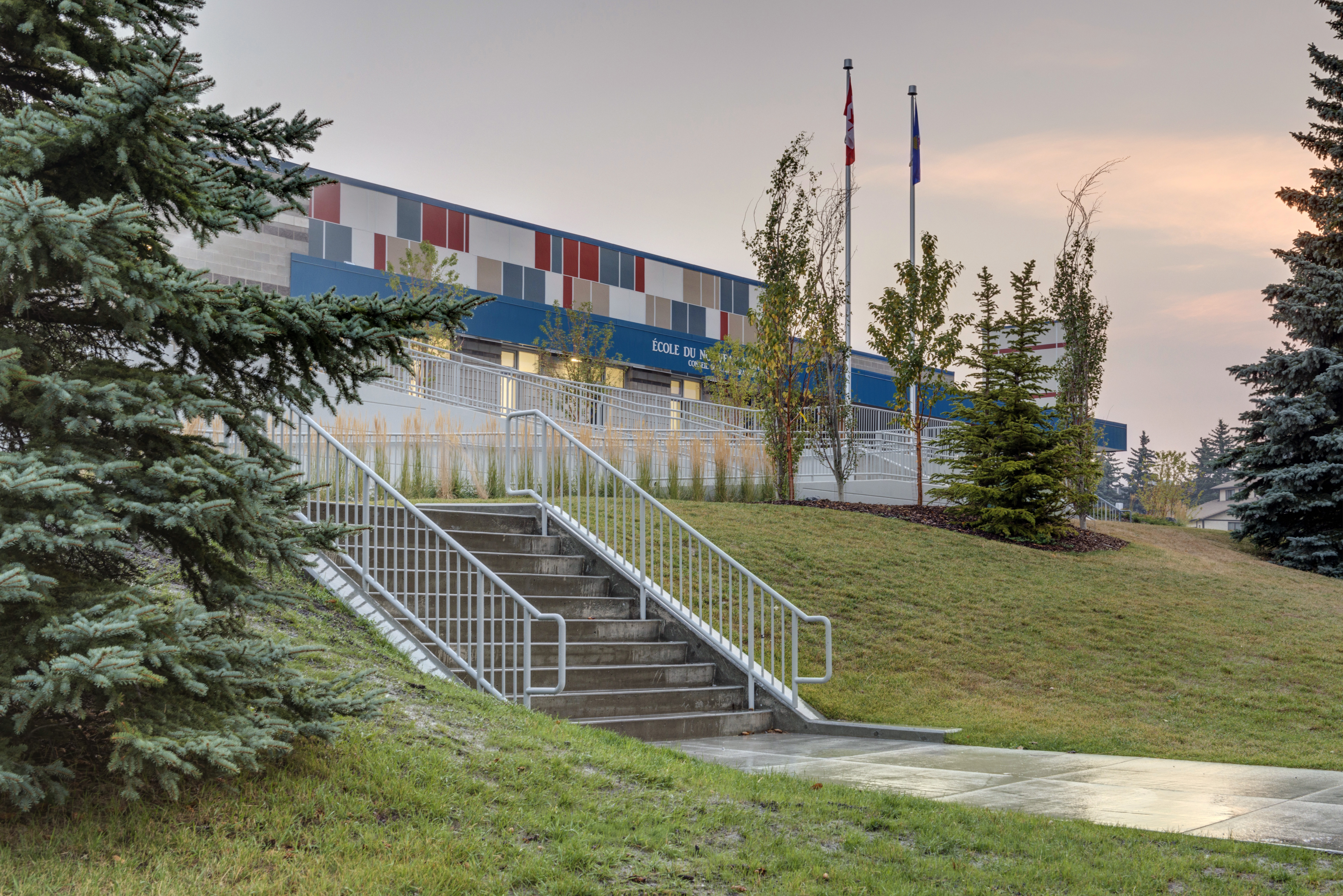 Exterior of Ecole du Nouveau Monde at sunset showing staircase