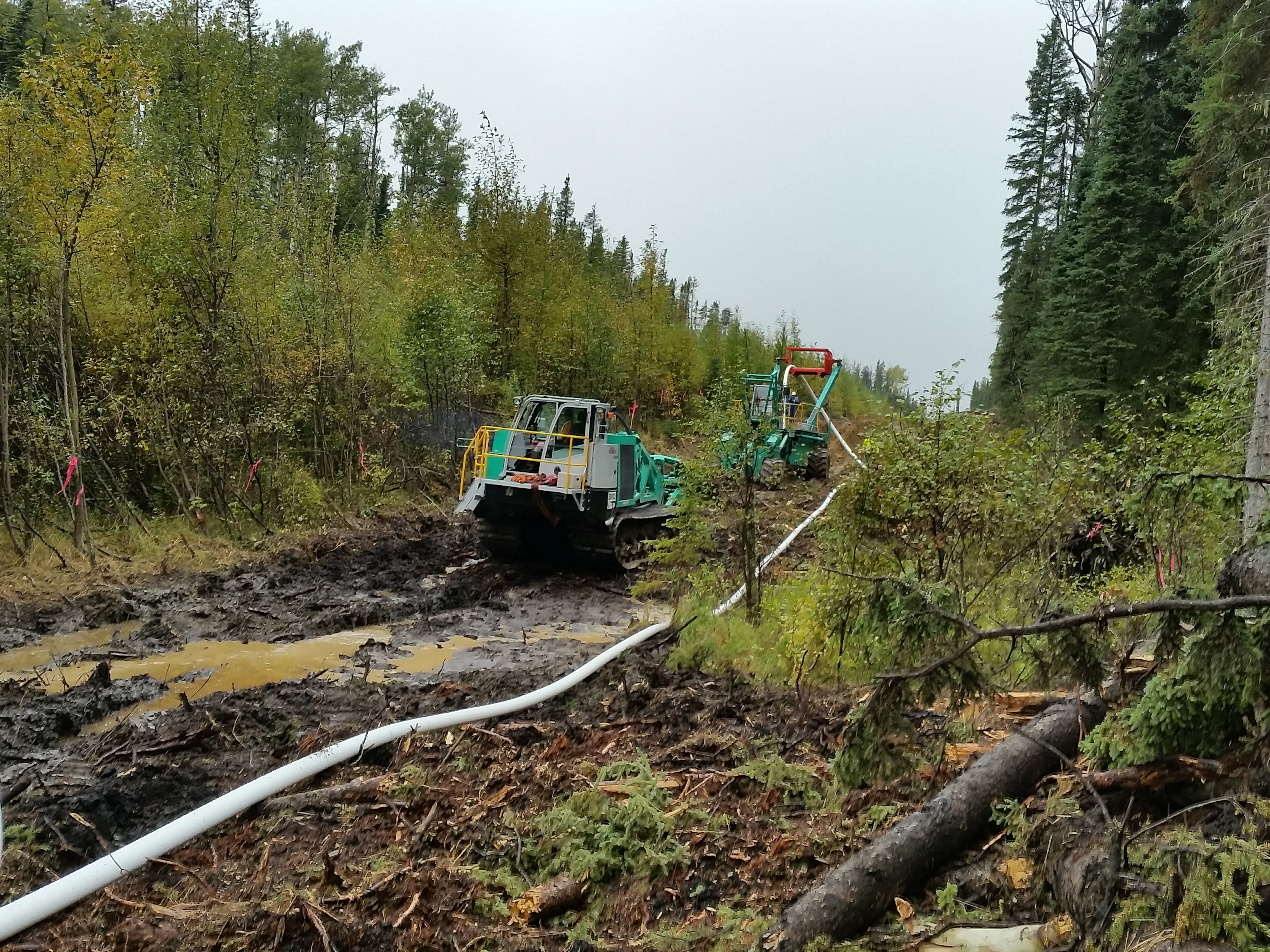 ITS machines laying pipe in a forest