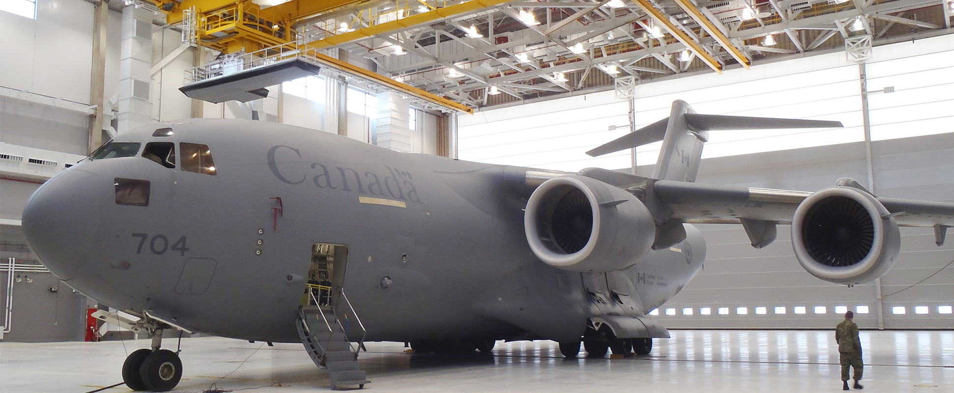 Interior of 8 Wing Canadian Forces Base Trenton Maintenance Hangar No. 1 showing an airplane parked inside the hangar